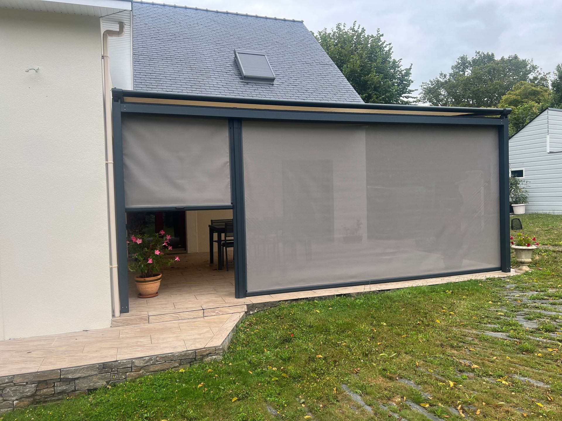 Stores Ziptrak avec une toile protection solaire installés sur une pergola