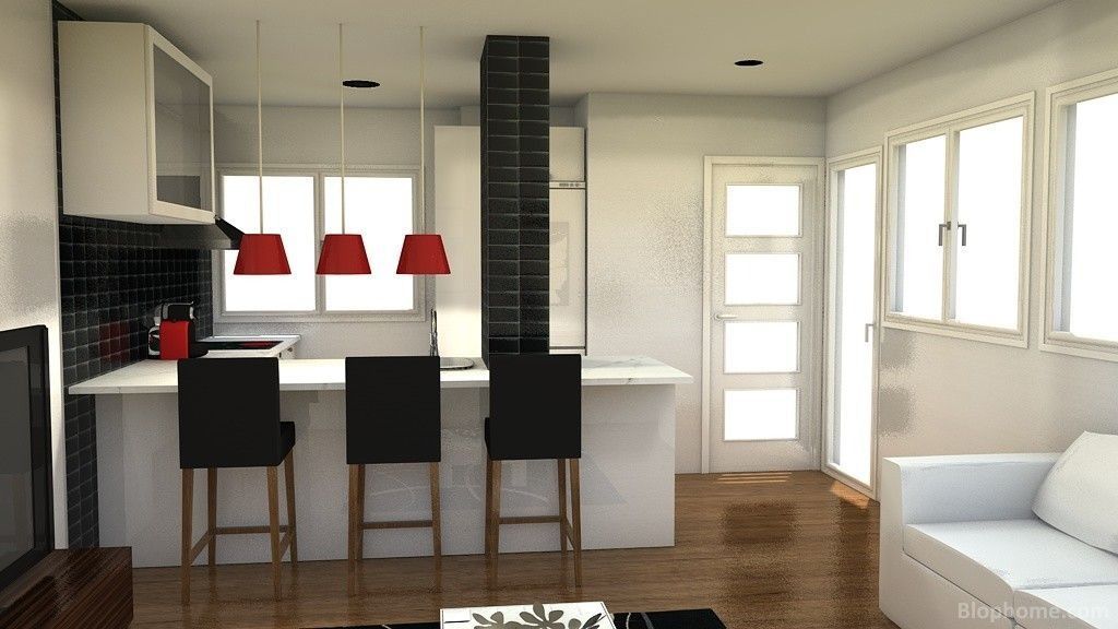 Una sala de estar con un sofá y una cocina.