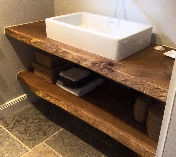 Un baño con un lavabo sobre un estante de madera.