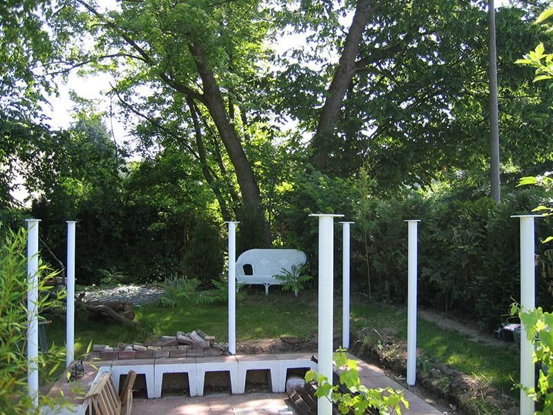 Eine weiße Bank steht mitten in einem Garten