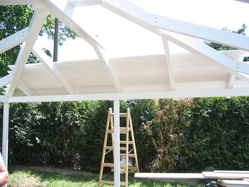 Eine Holzleiter sitzt unter einer weißen Struktur