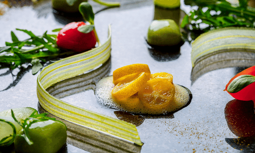 A close up of a plate of food with vegetables on a table.