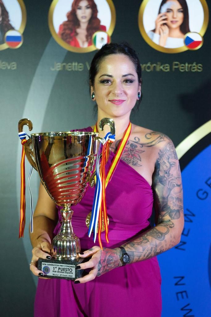 Una mujer con un vestido morado sostiene un trofeo.