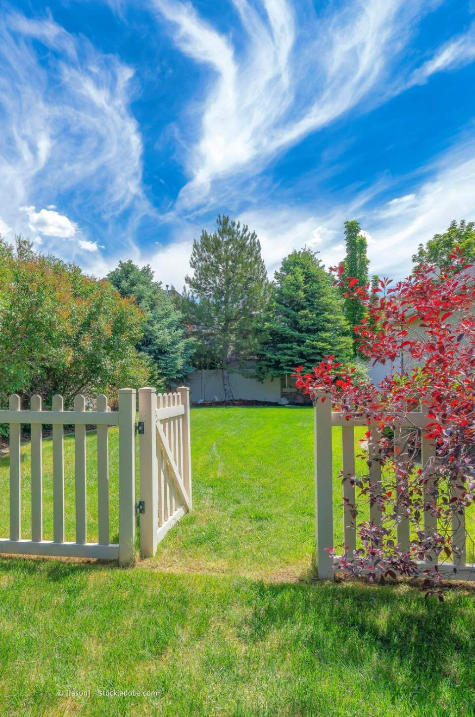 Garten- und Landschaftsbau M. Krusen – eine geöffnete Zauntür führt in einen Garten