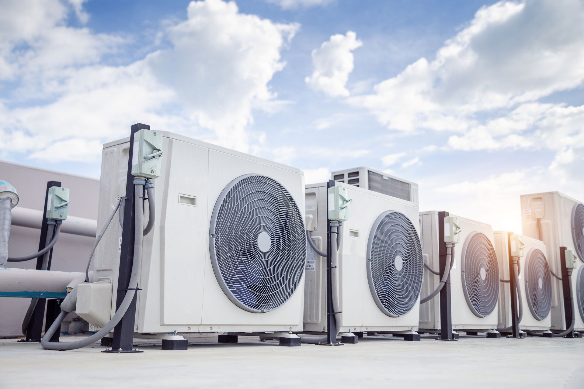 Une rangée de climatiseurs industriels à l'extérieur.