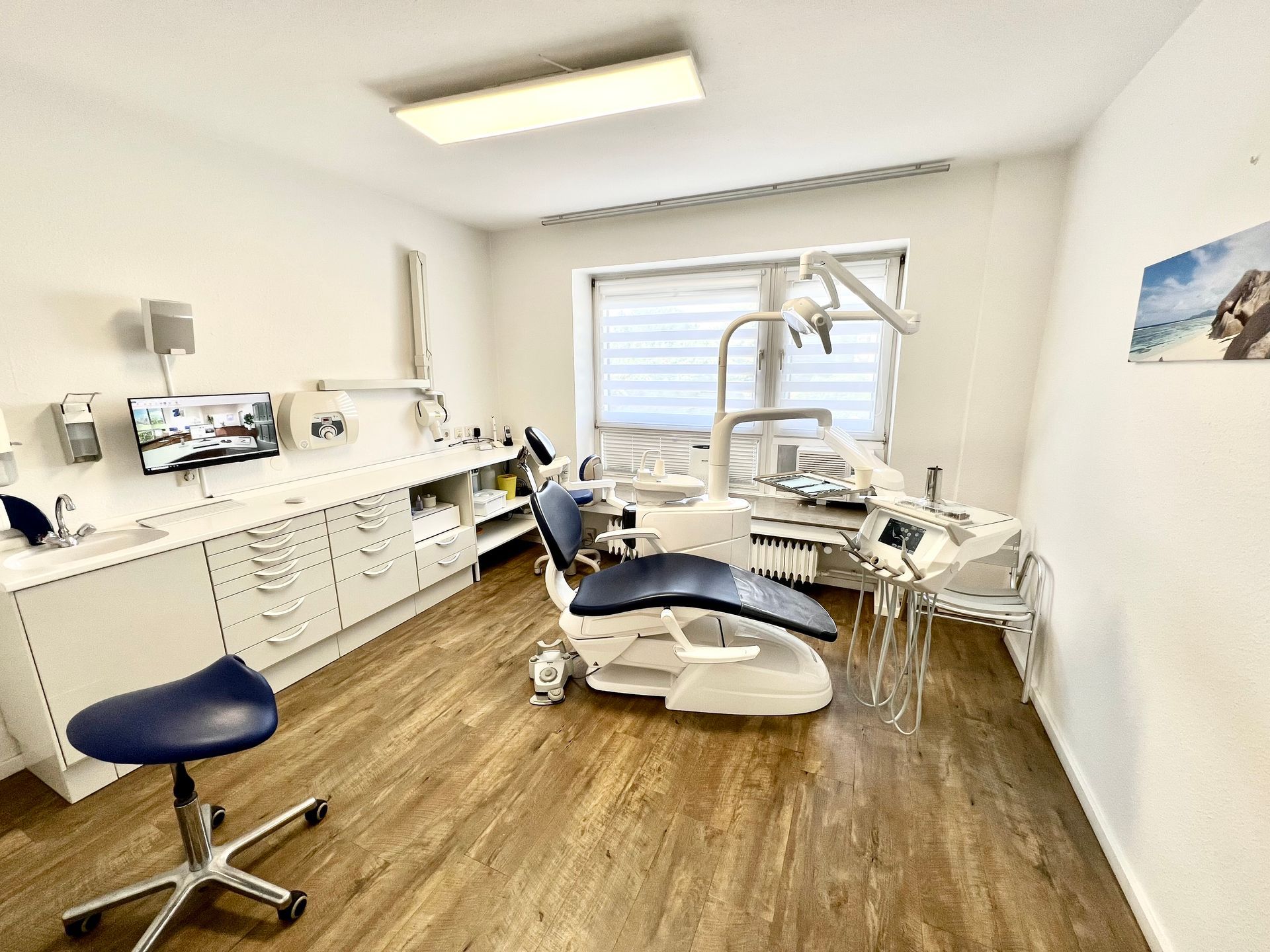 Zahnarztzimmer mit Stuhl, Instrumenten und Schränken in einer hellen, ordentlichen Klinik.