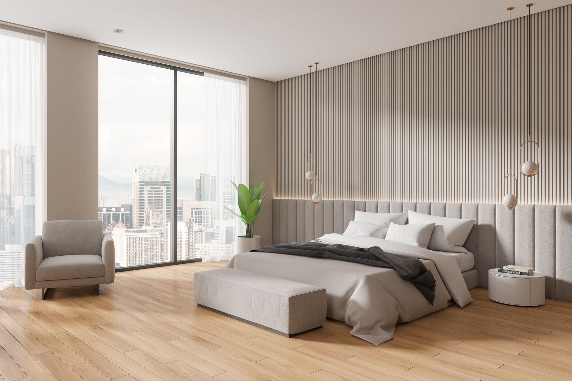 Chambre à coucher avec un fauteuil gris.