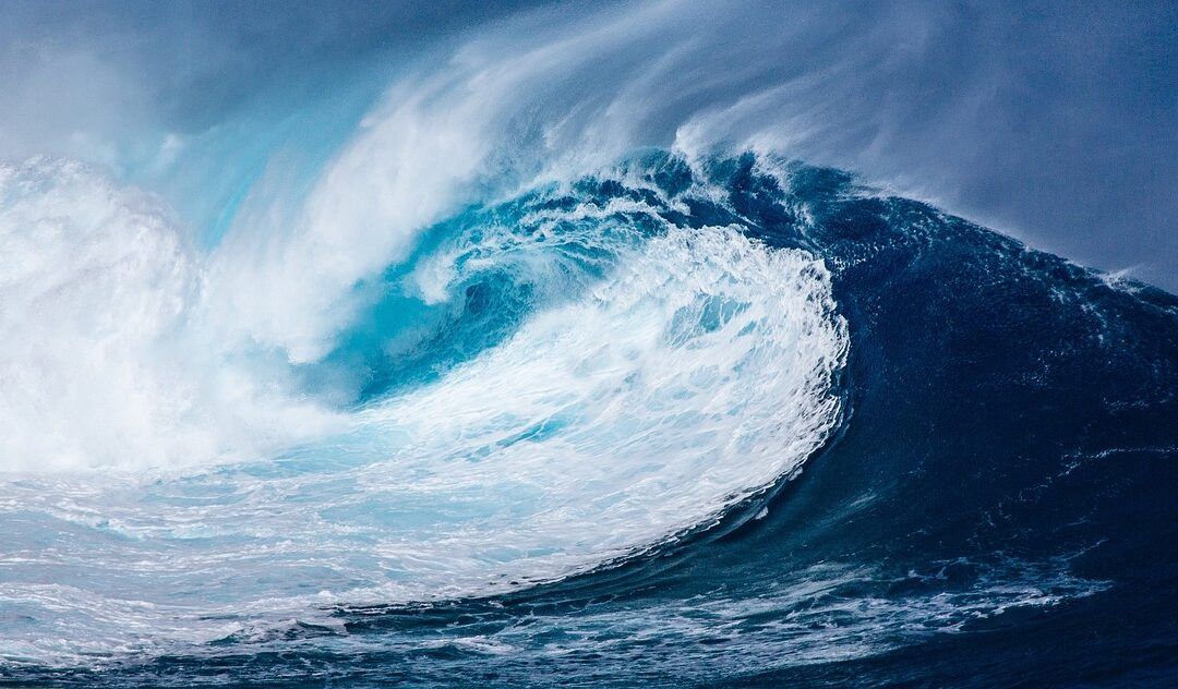 a powerful wave crashing in the open ocean, symbolising the intensity of emotional regulation challenges in neurodivergent people