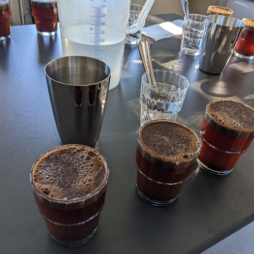 Ein Tisch mit einem Krug Wasser und ein paar Gläsern darauf