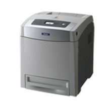 Una impresora gris está sobre una superficie blanca