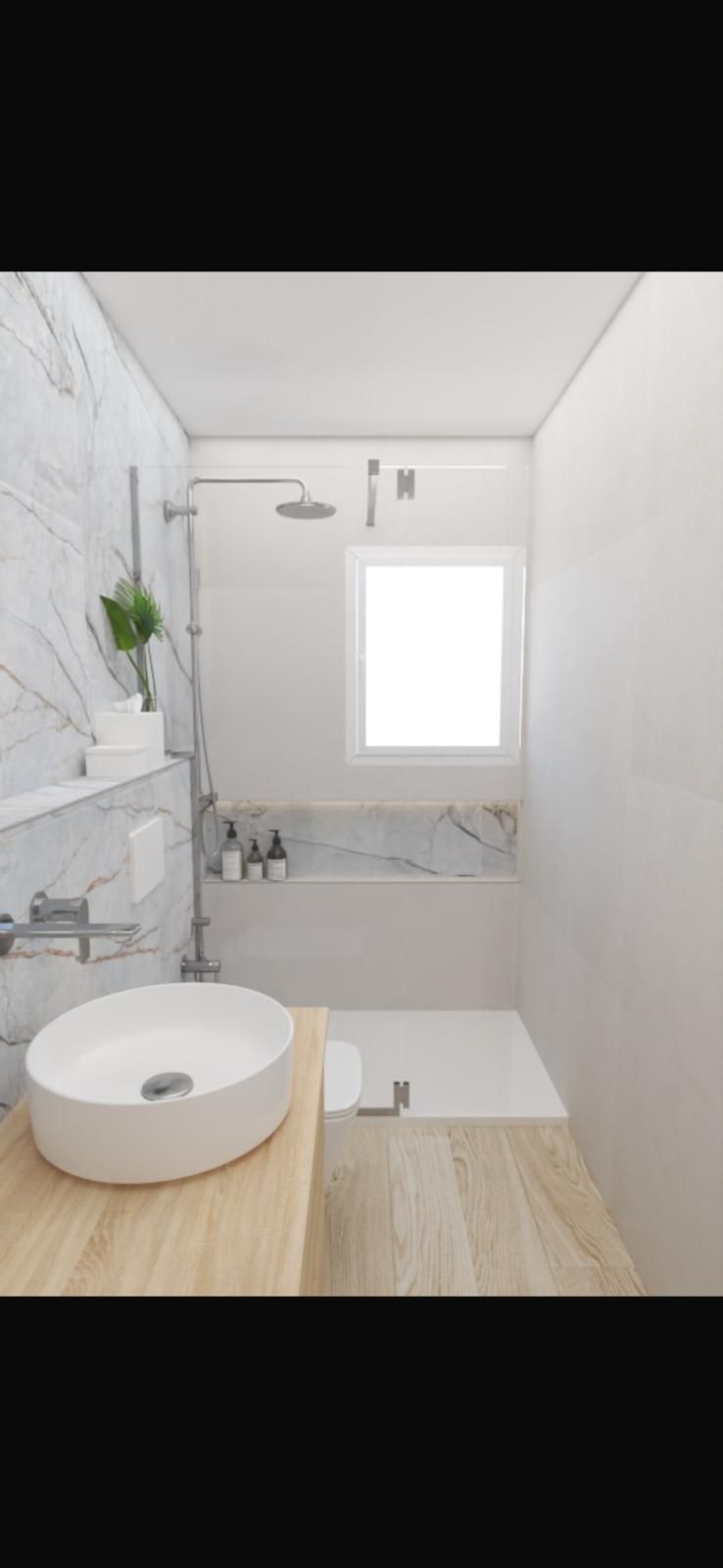 Un baño con lavabo, bañera, ducha y ventana.