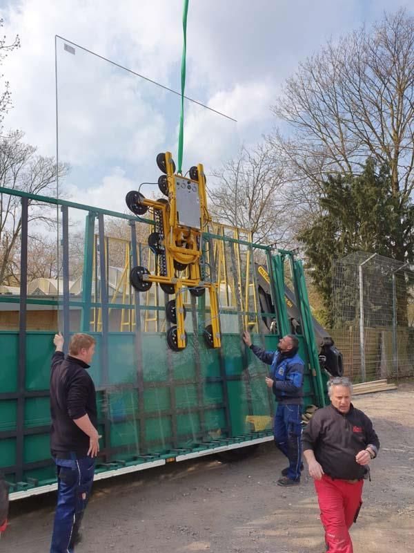 Eine Gruppe von Männern arbeitet an einem großen Stück Glas
