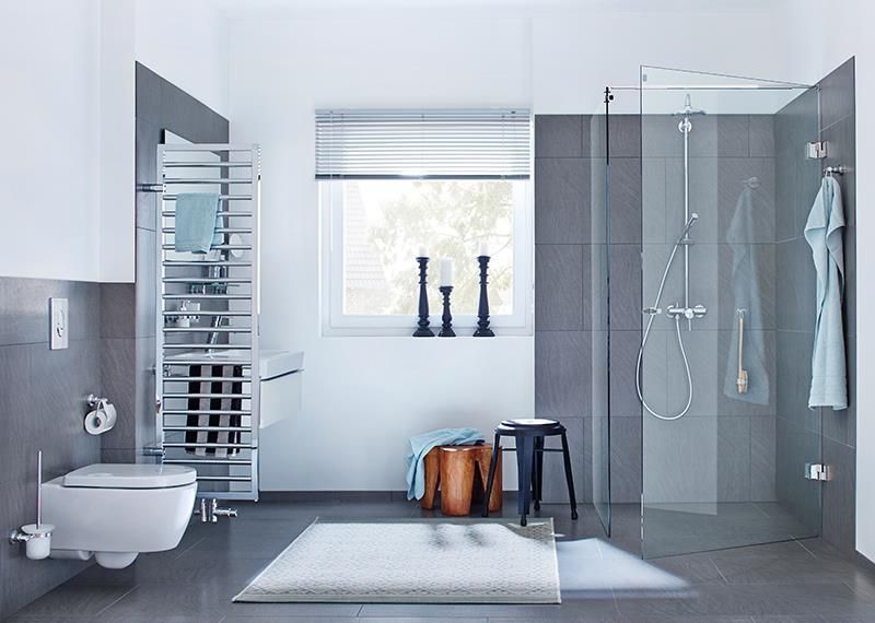 Ein Badezimmer mit Toilette, Waschbecken, Dusche und Fenster