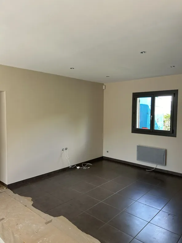 Pièce avec murs peints, sol en carrelage et plafond suspendu