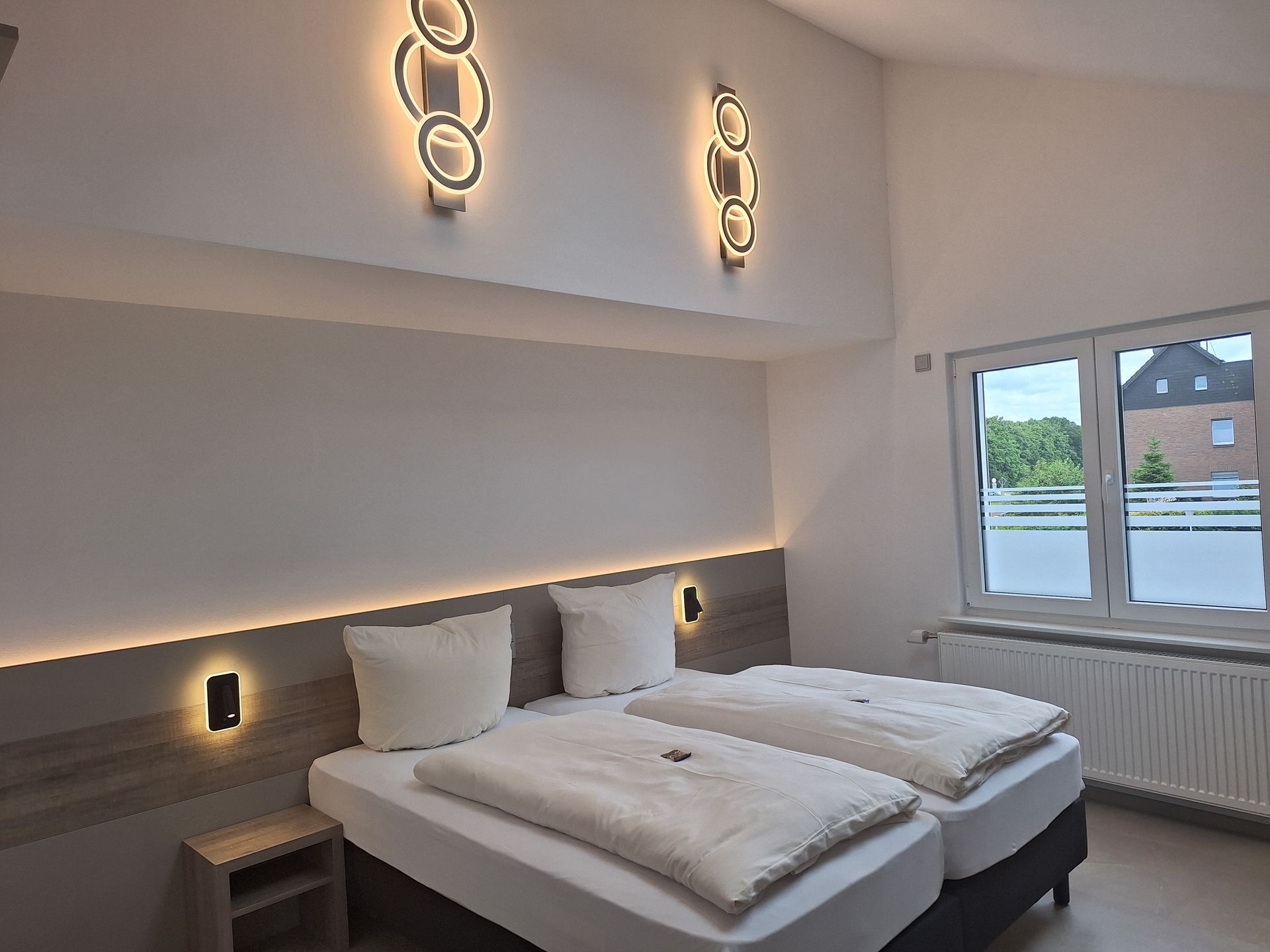 Modern beleuchtetes Hotelzimmer mit Doppelbett