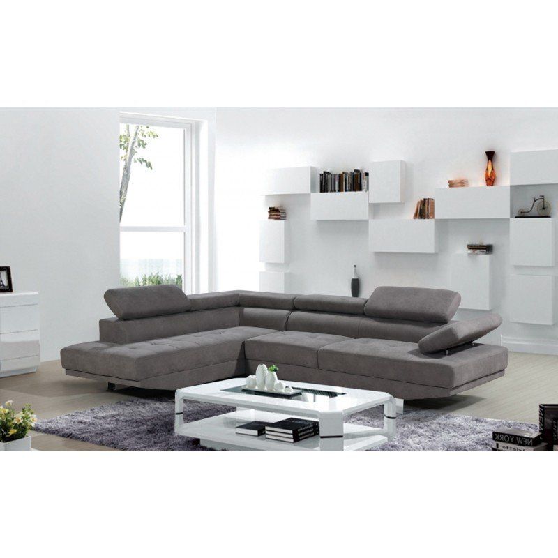 Sofá seccional gris en una moderna sala de estar blanca.