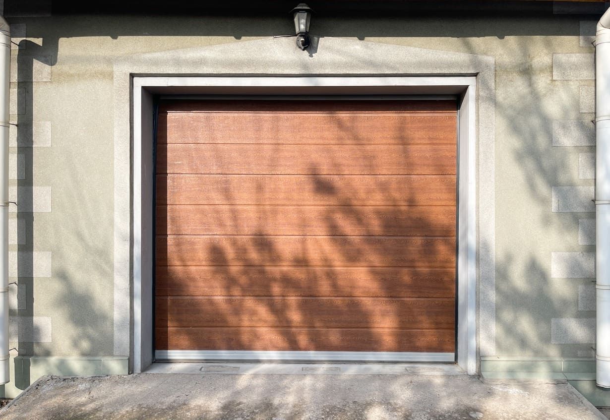 Una puerta de garaje de madera está en el costado de una casa.