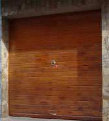 Un primer plano de una puerta de garaje de madera en un edificio.