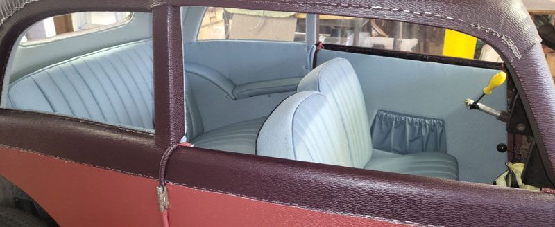 Eine Nahaufnahme des Inneren eines Autos mit blauen Sitzen.