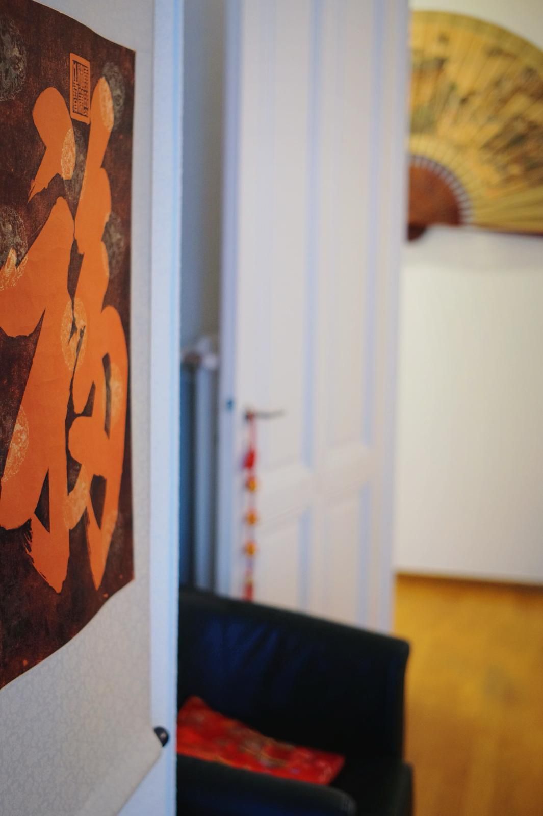 Une pièce avec une chaise et un tableau au mur