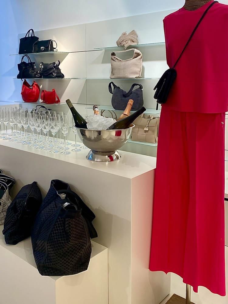 Ein rosa Kleid hängt an einer Schaufensterpuppe in einem Geschäft