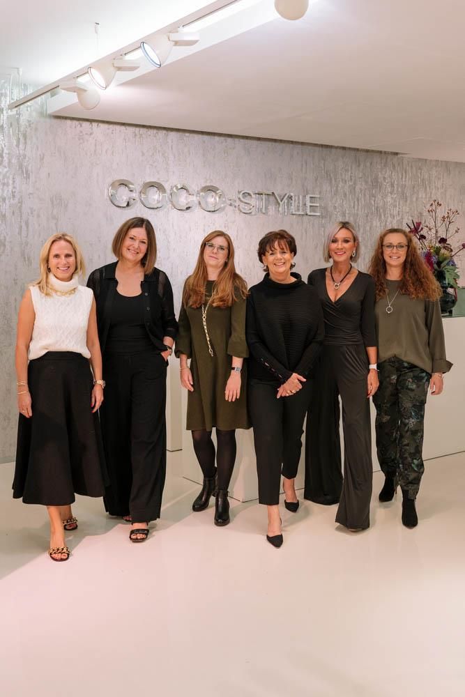 Eine Gruppe von Frauen steht nebeneinander in einem Raum.