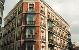 Un gran edificio de ladrillo con muchas ventanas y balcones.
