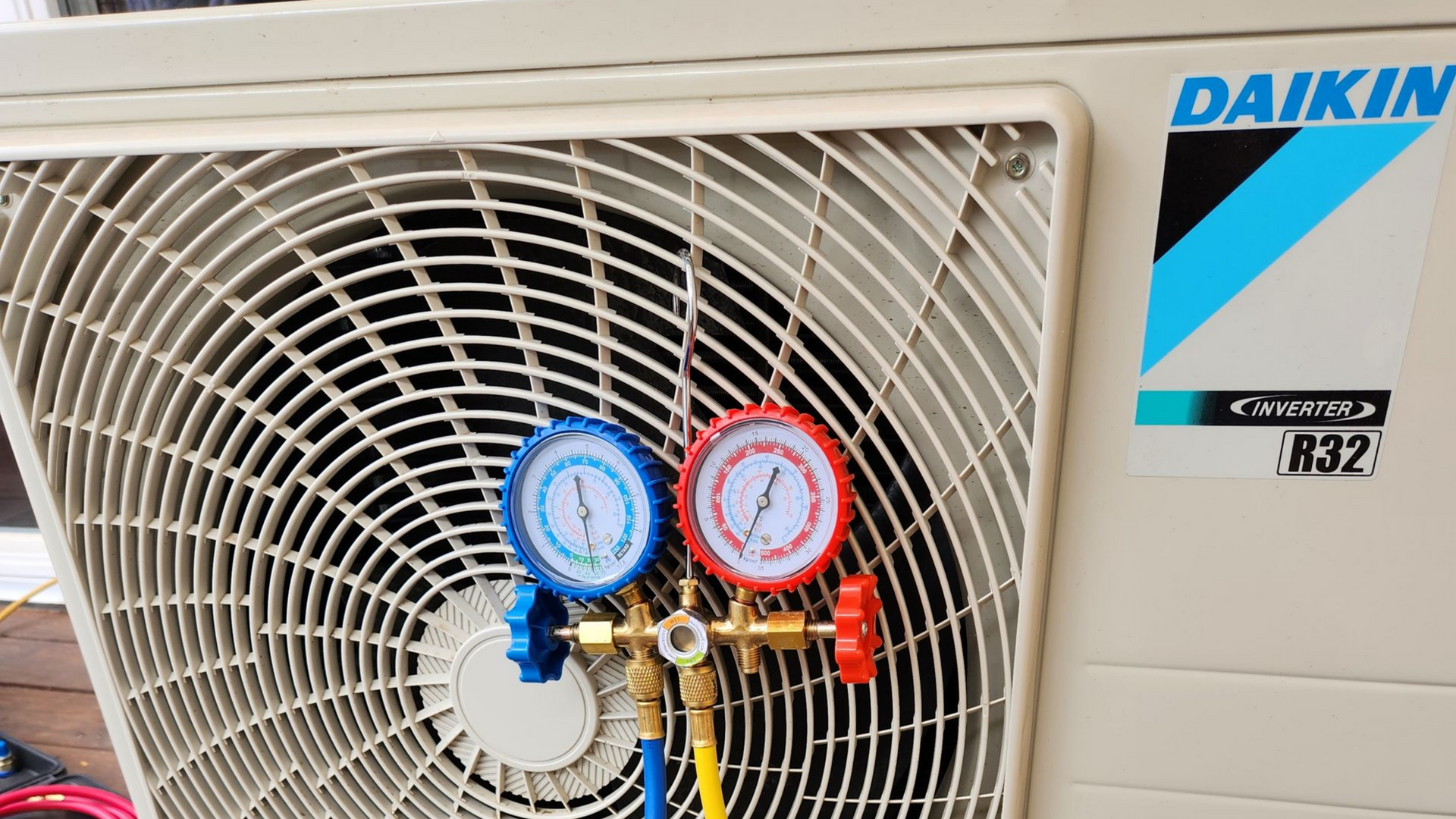 Unité extérieure de climatisation Daikin avec manomètres de climatisation fixés à la grille avant
