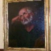 Un cuadro de un hombre con barba está colgado en una pared.