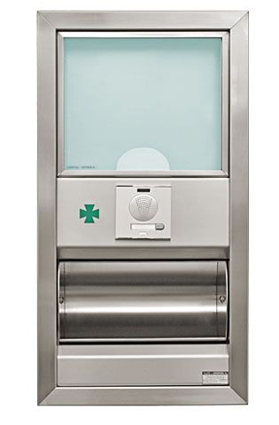 Un dispensador de farmacia de acero inoxidable con una cruz verde.