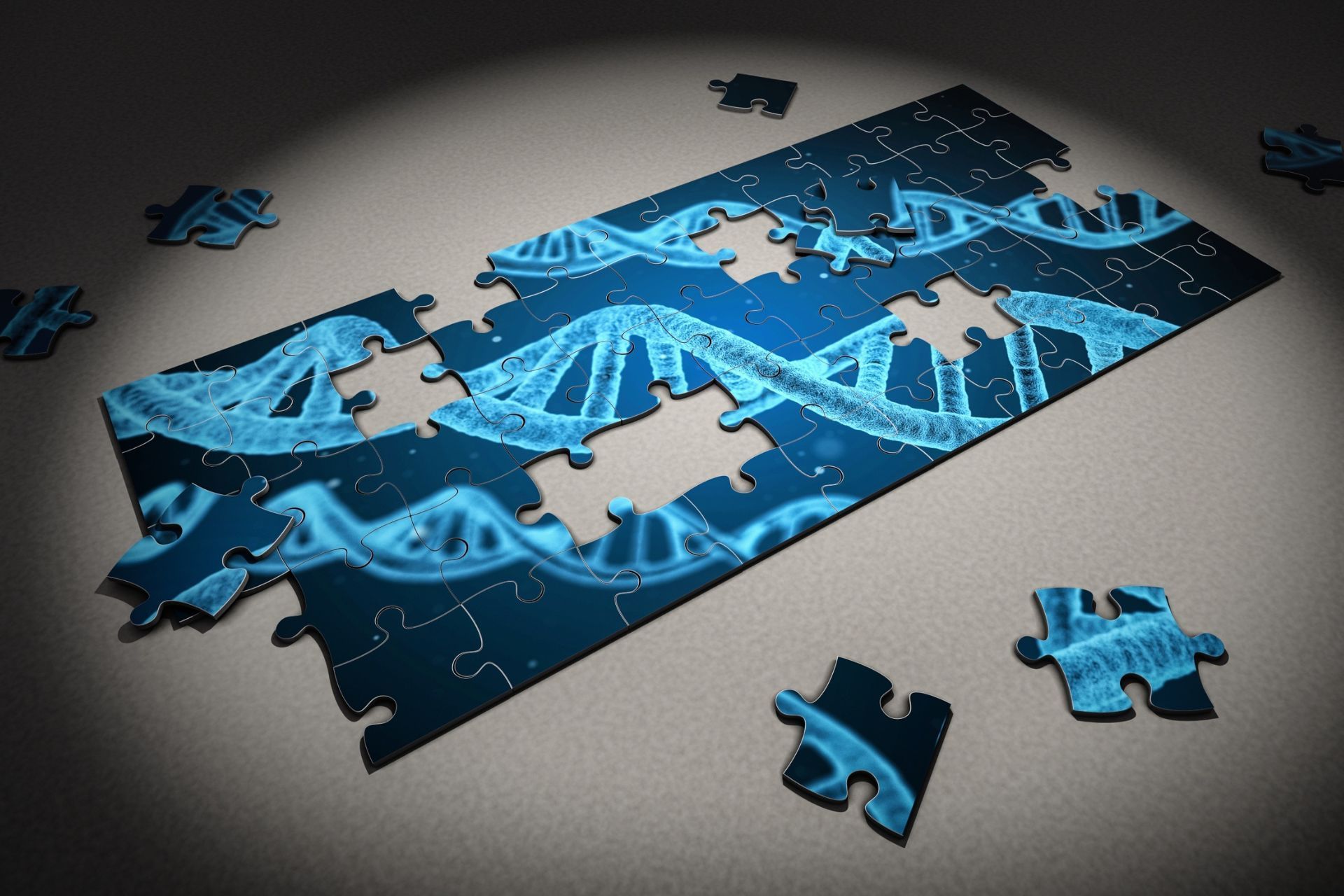 Un rompecabezas parcialmente ensamblado que representa una doble hélice de ADN en tonos de azul, con varias piezas sueltas esparcidas por todas partes.