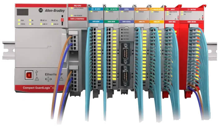 Compact GuardLogix programmable automation controller with connected modules, wires attached, mounted on a rail.