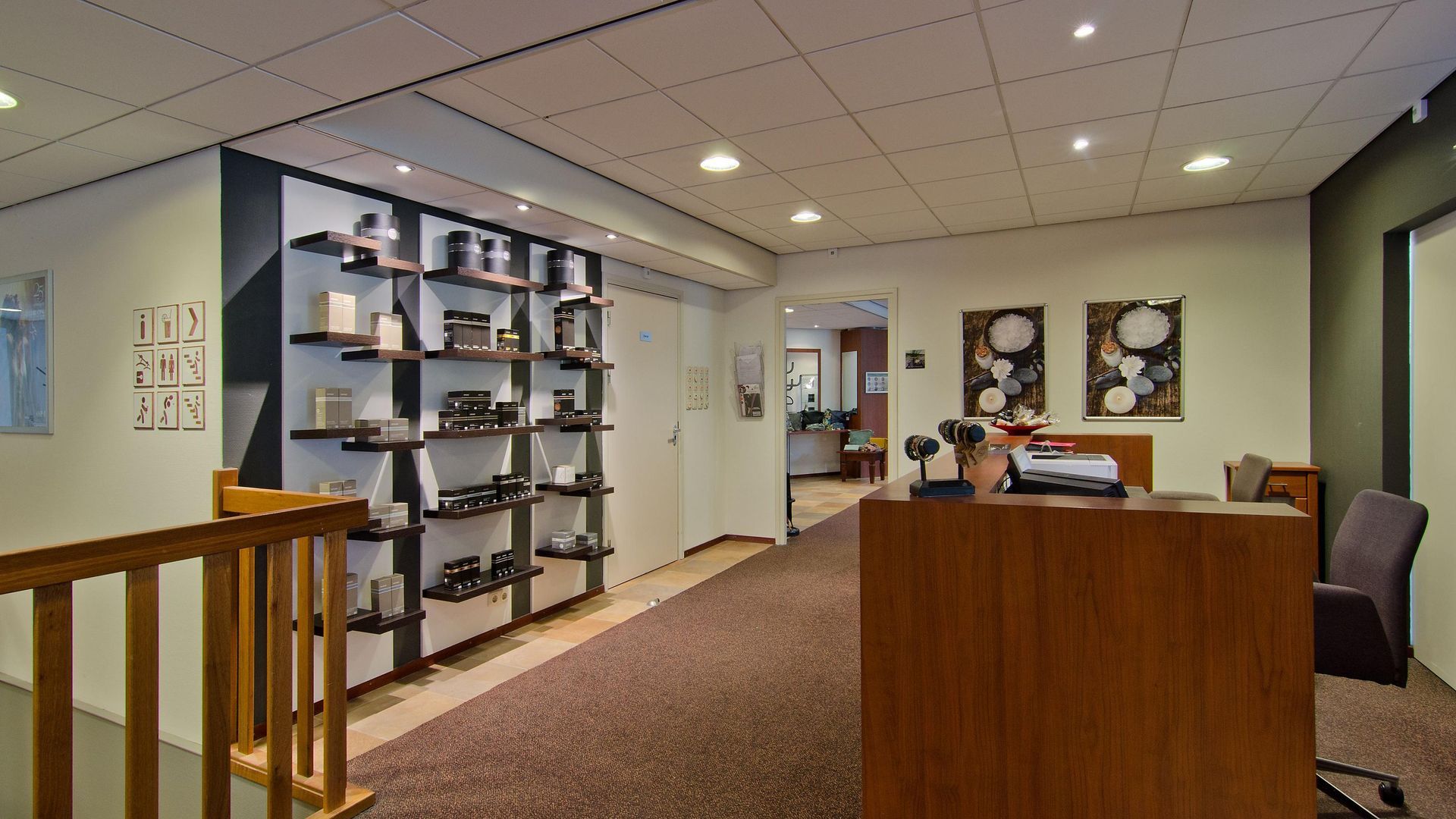 A large room with a wooden desk and shelves.