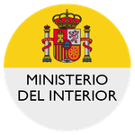 Logotipo del Ministerio del Interior español con escudo de armas sobre fondo circular amarillo y blanco.