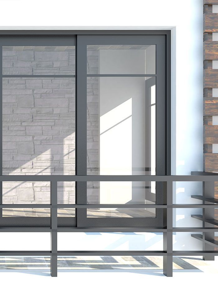 Porte coulissante grise avec panneaux de verre et rambarde noire sur un bâtiment blanc à revêtement en pierre.