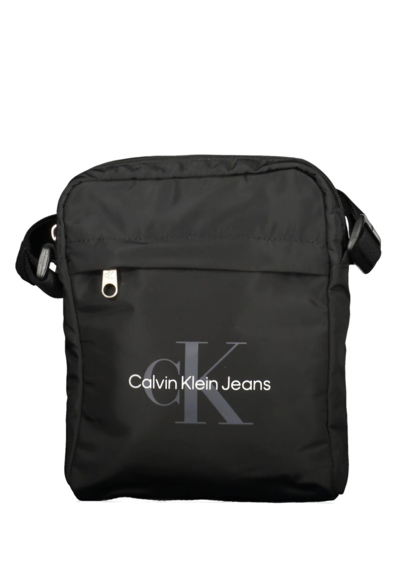 Un bolso bandolera negro de Calvin Klein Jeans sobre un fondo blanco.