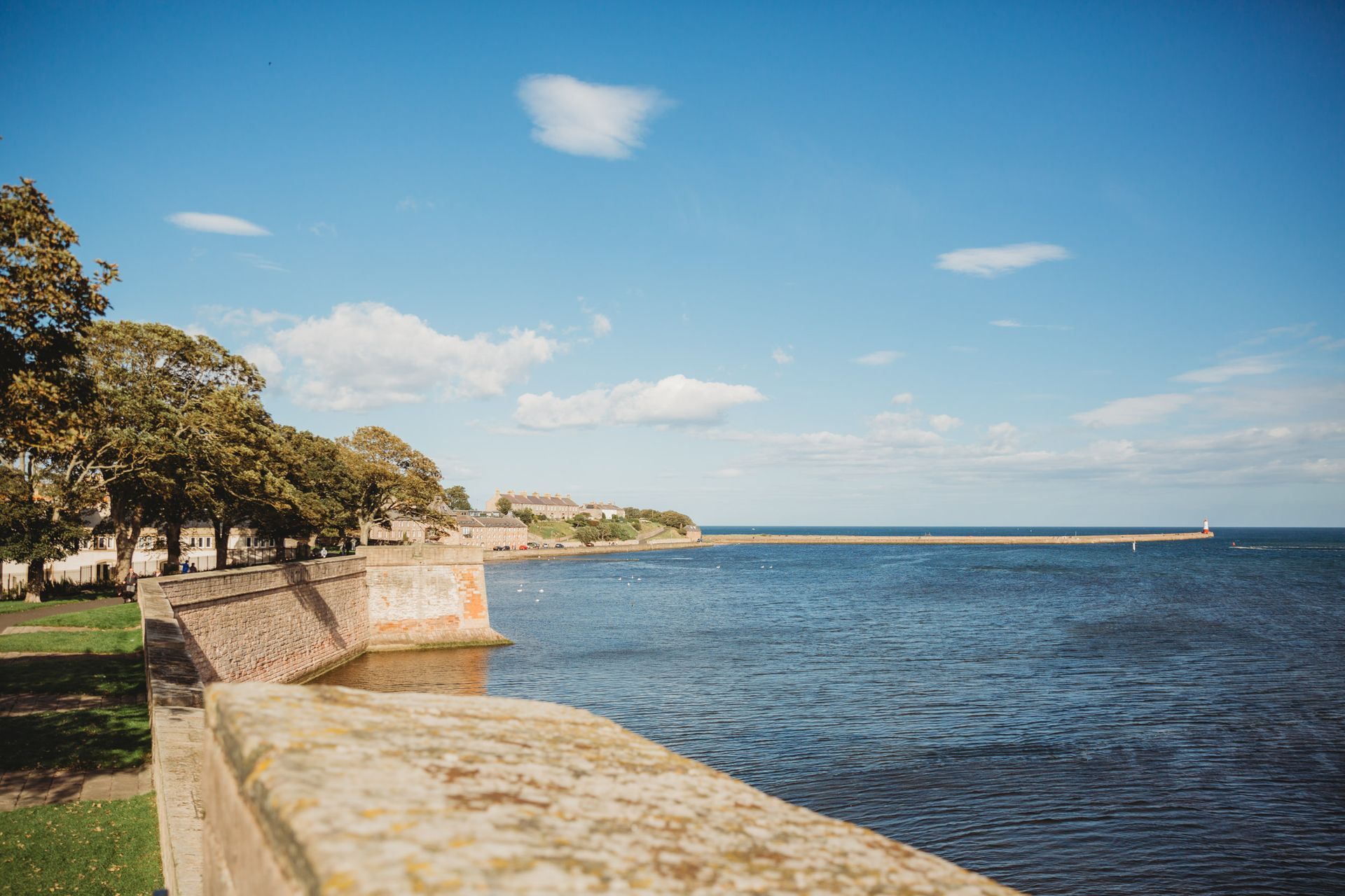 Berwick's fortifications and pier road with lighthouse, with river and sea views