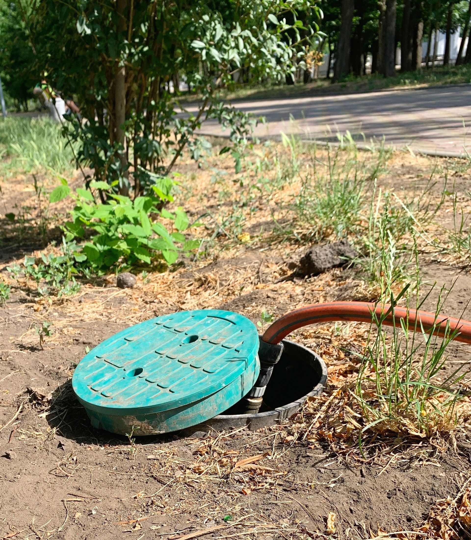 Un tuyau sortant d'un trou mi-fermé avec un couvercle