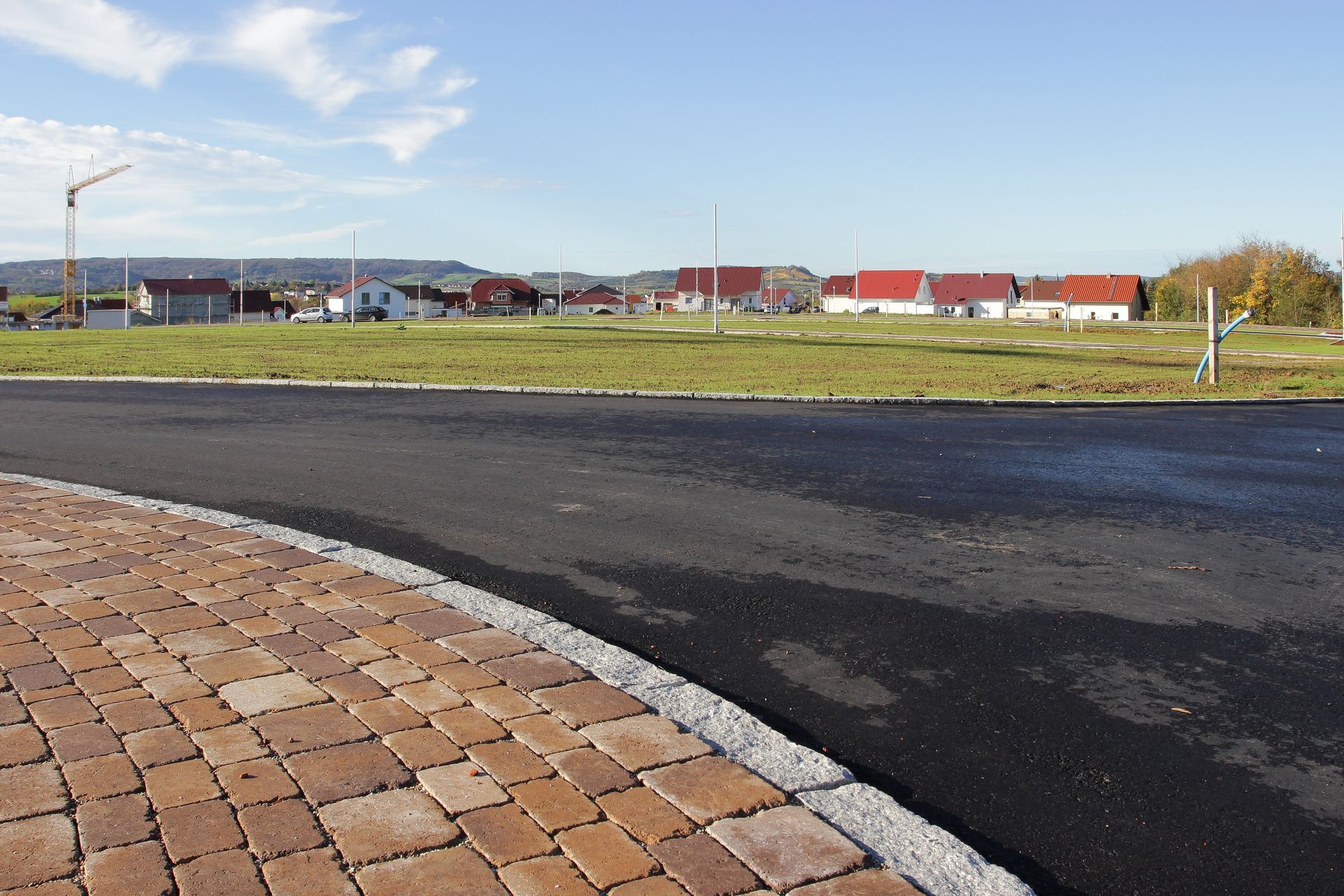 Un chemin en macadam avec des pavés sur le côté