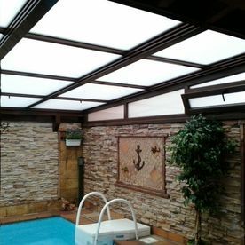 Una piscina en una habitación con una pared de ladrillos.