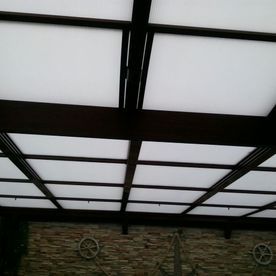 Un techo con muchos cuadrados y una pared de ladrillos.