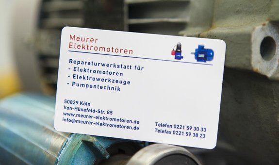 A business card for neuer elektromotoren is on a motor