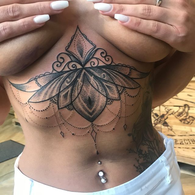 Eine Frau hat eine Tätowierung einer Blume auf ihrer Brust