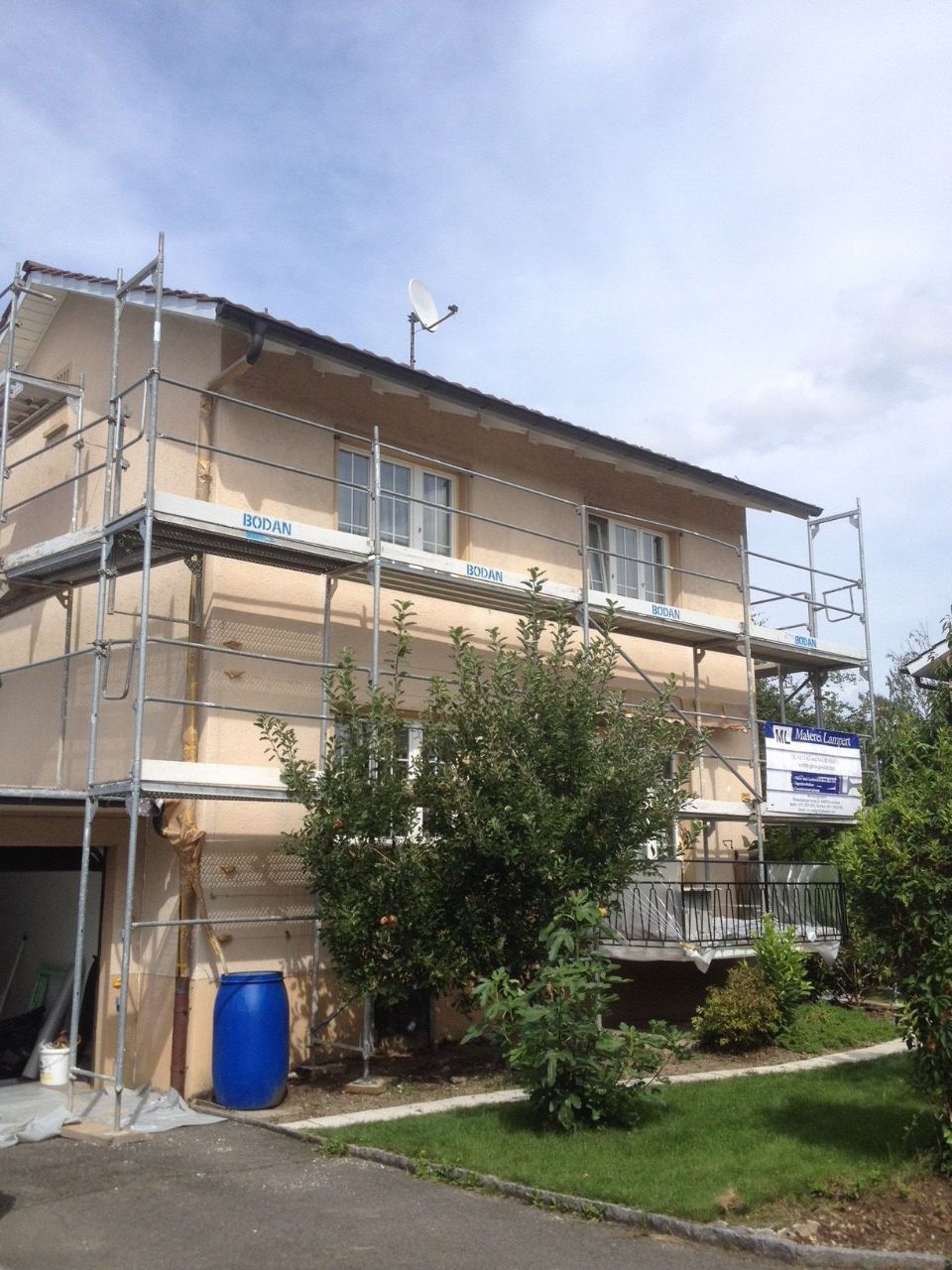 Gerüst an einer Hausfassade, Arbeit der Malerei Lampert