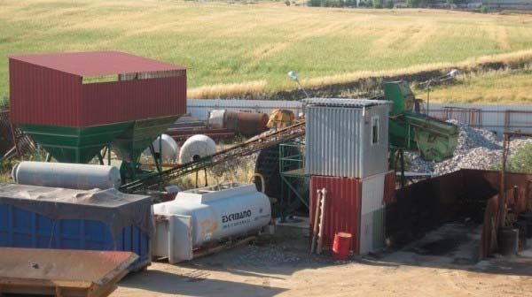 Un almacén con un camión cisterna en el medio.