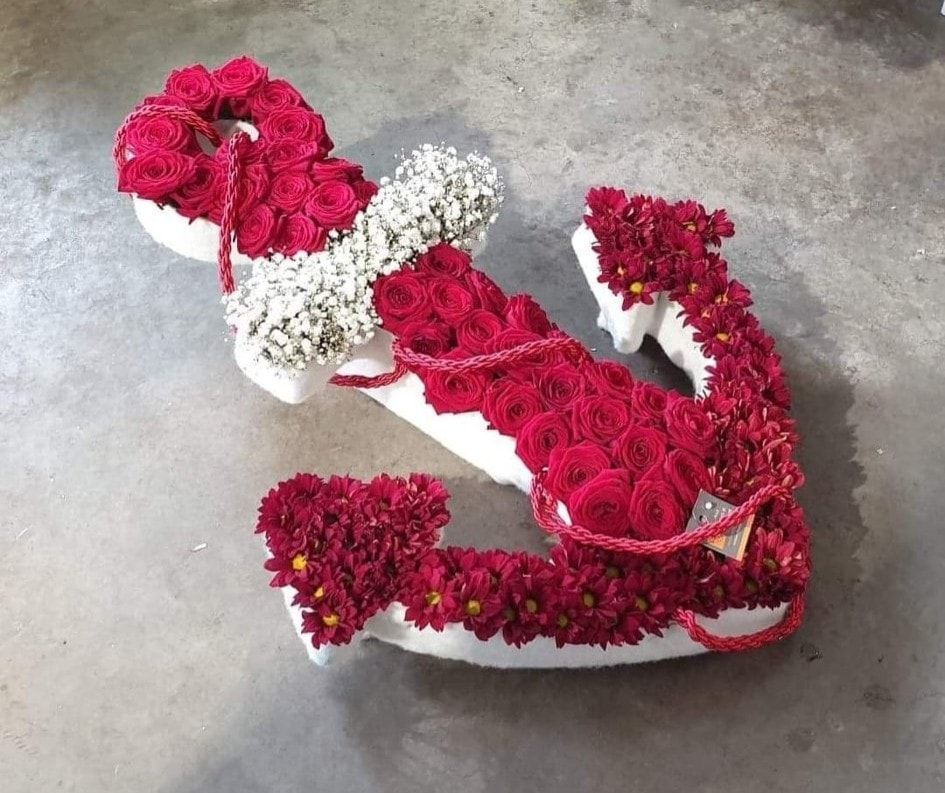 Encre marine en dessus de cerceuil composée de roses rouges