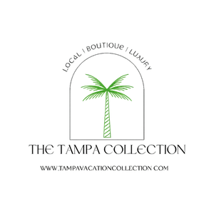 A black and white logo for tampa collection with a palm tree.