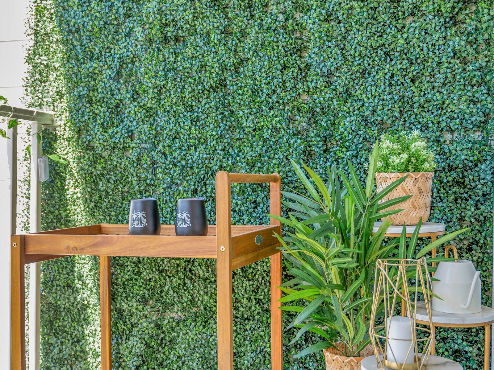 A wooden cart is sitting in front of a green wall.