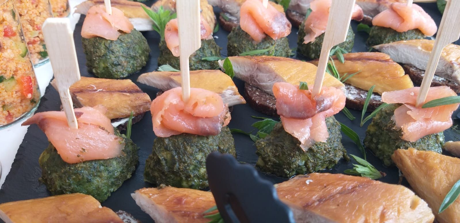 Ein Tisch mit verschiedenen Speisen auf Spießen.