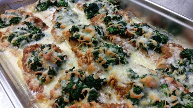 Ein Auflaufgericht gefüllt mit Hühnchen, Spinat und Käse.